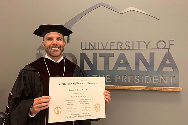 UM President Seth Bodnar holds a degree in his Commencement regalia.